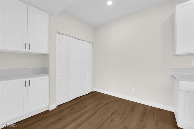 5174 S Jones Blvd Unit 105, Las Vegas, NV 89118 - unfurnished dining area featuring wood finished floors and recessed lighting