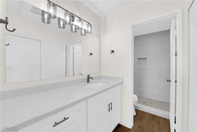 5174 S Jones Blvd Unit 105, Las Vegas, NV 89118 - bathroom with vanity, wood finished floors, and a tile shower