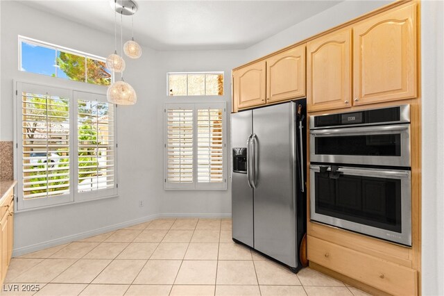 9136 Eagle Ridge Dr, Las Vegas, NV 89134 - kitchen featuring appliances with stainless steel finishes, light brown cabinets, healthy amount of natural light, and pendant lighting