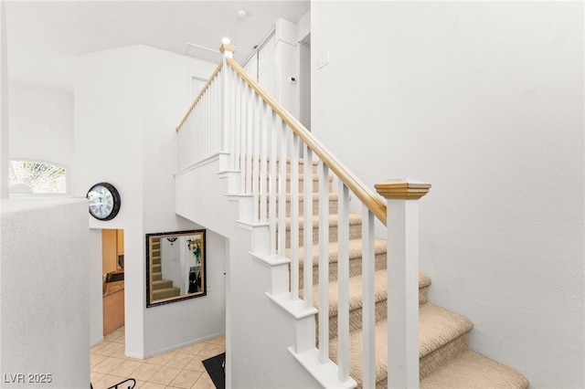 9136 Eagle Ridge Dr, Las Vegas, NV 89134 - stairway with a high ceiling and tile patterned flooring