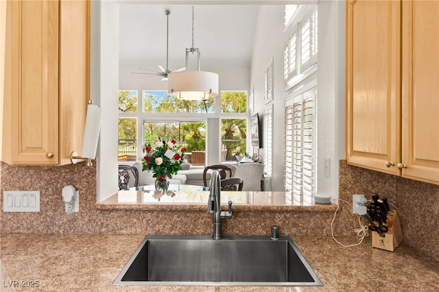 9136 Eagle Ridge Dr, Las Vegas, NV 89134 - kitchen with ceiling fan, light brown cabinets, backsplash, a towering ceiling, and open floor plan