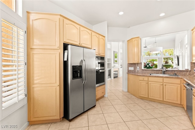 9136 Eagle Ridge Dr, Las Vegas, NV 89134 - kitchen with stainless steel appliances, light brown cabinetry, backsplash, light tile patterned flooring, and recessed lighting