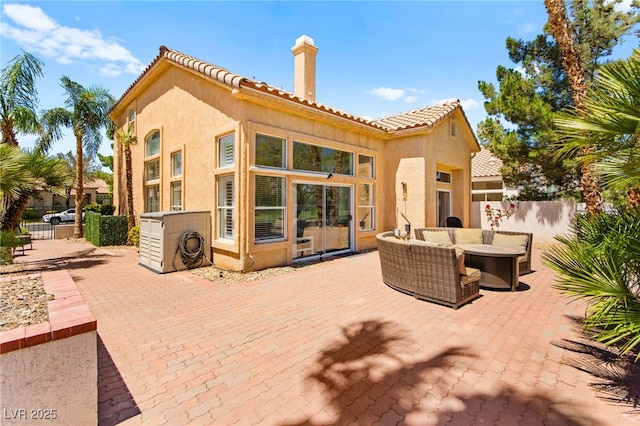 9136 Eagle Ridge Dr, Las Vegas, NV 89134 - back of property with a chimney, a patio area, stucco siding, and outdoor lounge area