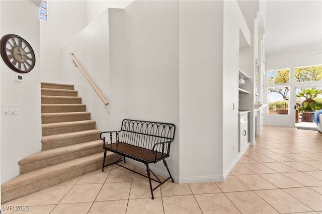 9136 Eagle Ridge Dr, Las Vegas, NV 89134 - staircase with a towering ceiling and tile patterned flooring