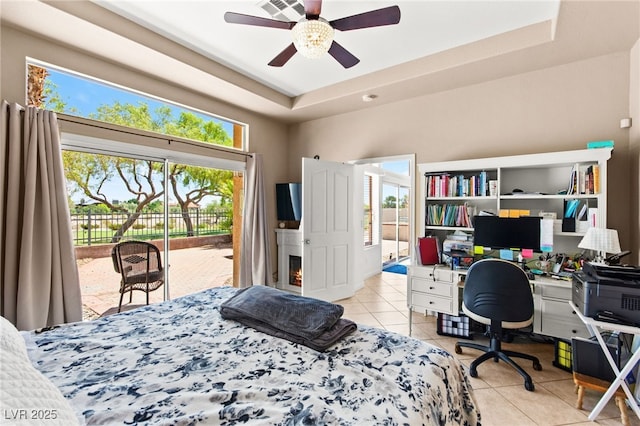 9136 Eagle Ridge Dr, Las Vegas, NV 89134 - bedroom featuring access to exterior, light tile patterned flooring, a desk, a tray ceiling, and ceiling fan