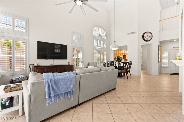 9136 Eagle Ridge Dr, Las Vegas, NV 89134 - living area with high vaulted ceiling, ceiling fan, light tile patterned floors, and healthy amount of natural light