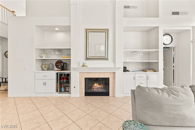 9136 Eagle Ridge Dr, Las Vegas, NV 89134 - living area with built in features, wine cooler, light tile patterned floors, and a bar