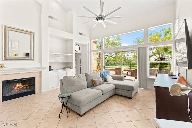 9136 Eagle Ridge Dr, Las Vegas, NV 89134 - living room with built in shelves, high vaulted ceiling, ceiling fan, healthy amount of natural light, and light tile patterned floors