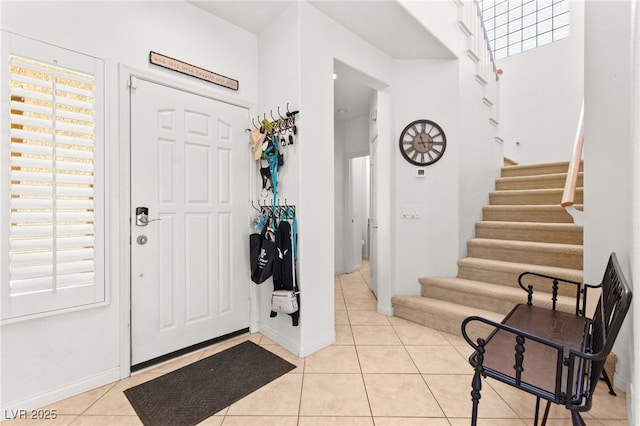 9136 Eagle Ridge Dr, Las Vegas, NV 89134 - foyer with light tile patterned floors and stairway