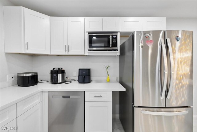 3361 Horizon St, Las Vegas, NV 89121 - kitchen featuring stainless steel appliances, white cabinets, and light countertops
