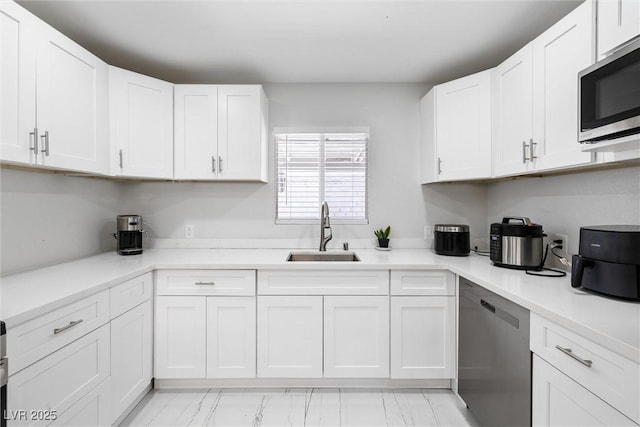 3361 Horizon St, Las Vegas, NV 89121 - kitchen featuring appliances with stainless steel finishes, white cabinets, and light countertops