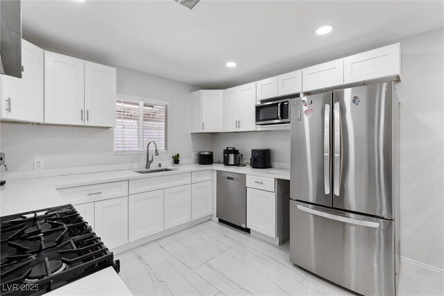 3361 Horizon St, Las Vegas, NV 89121 - kitchen with stainless steel appliances, white cabinets, light marble finish flooring, light countertops, and recessed lighting