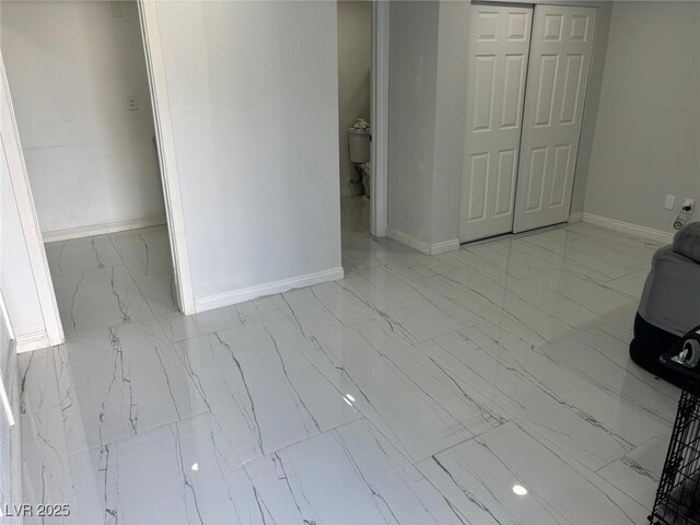3361 Horizon St, Las Vegas, NV 89121 - unfurnished living room featuring marble look tiles and baseboards