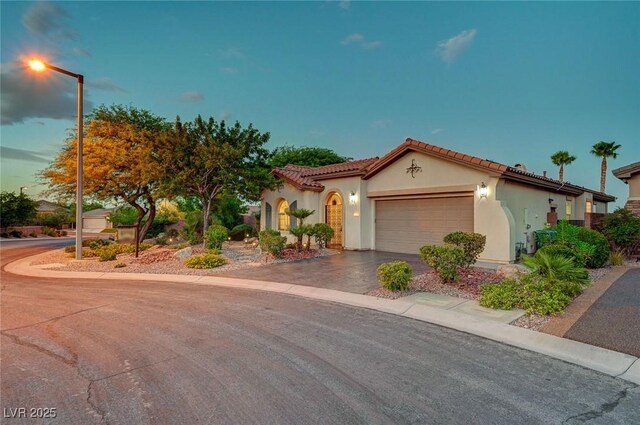 212 Florio Ct, Las Vegas, NV 89138 - mediterranean / spanish-style home with concrete driveway, stucco siding, a garage, and a tiled roof