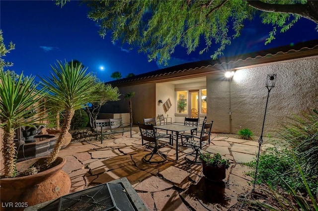 212 Florio Ct, Las Vegas, NV 89138 - patio at night with a patio and outdoor dining space