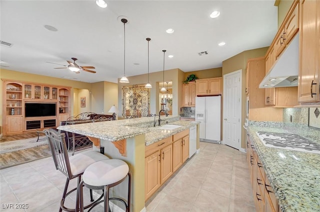 212 Florio Ct, Las Vegas, NV 89138 - kitchen featuring white appliances, light brown cabinets, light tile patterned flooring, a ceiling fan, and a center island with sink