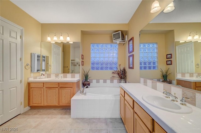 212 Florio Ct, Las Vegas, NV 89138 - bathroom featuring two vanities, a garden tub, and tile patterned floors