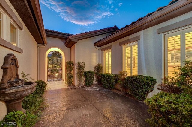 212 Florio Ct, Las Vegas, NV 89138 - property entrance featuring a patio area, a tile roof, and stucco siding