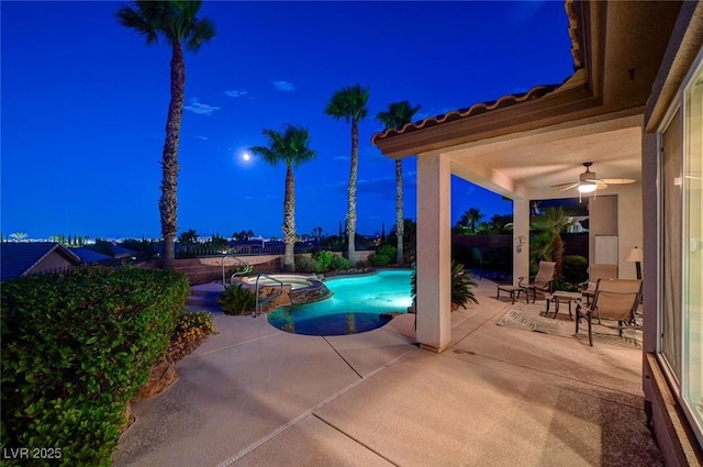 212 Florio Ct, Las Vegas, NV 89138 - pool at twilight with a patio, ceiling fan, a pool with connected hot tub, and a fenced backyard