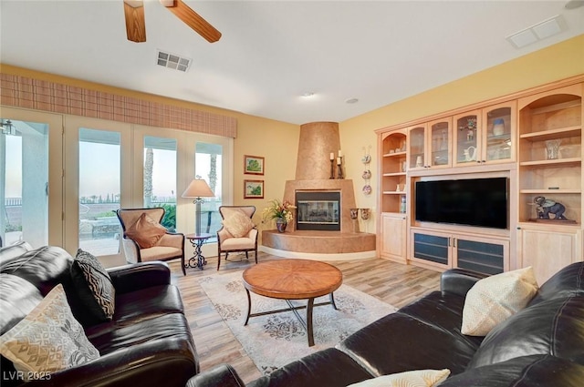 212 Florio Ct, Las Vegas, NV 89138 - living room with ceiling fan, light wood-style flooring, and a fireplace