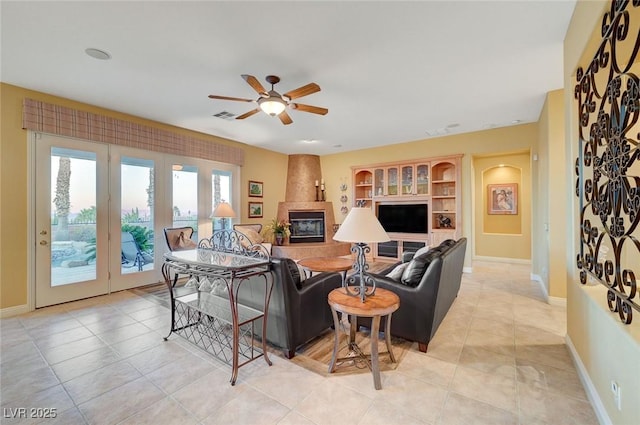 212 Florio Ct, Las Vegas, NV 89138 - living room featuring a ceiling fan, a large fireplace, and light tile patterned flooring