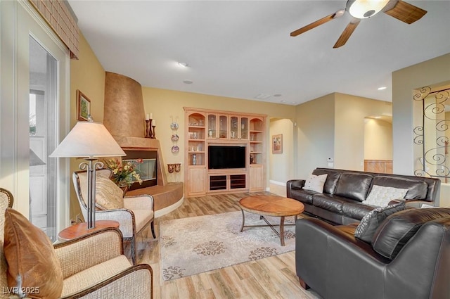 212 Florio Ct, Las Vegas, NV 89138 - living room featuring ceiling fan, light wood-type flooring, and arched walkways