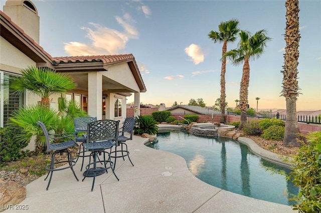212 Florio Ct, Las Vegas, NV 89138 - pool at dusk featuring a patio area, a fenced backyard, and a pool with connected hot tub