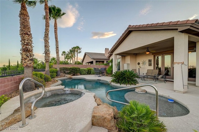 212 Florio Ct, Las Vegas, NV 89138 - pool at dusk with ceiling fan, a patio area, a fenced backyard, and a pool with connected hot tub