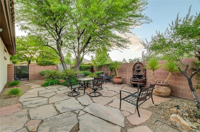 212 Florio Ct, Las Vegas, NV 89138 - fenced backyard featuring a patio, a gate, and outdoor dining area
