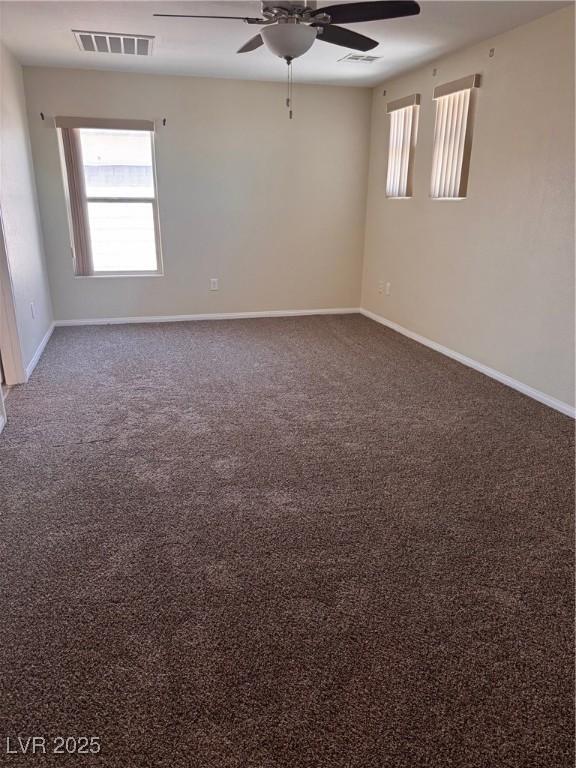 32 Yellow Peak Ave, North Las Vegas, NV 89031 - carpeted empty room with ceiling fan and plenty of natural light