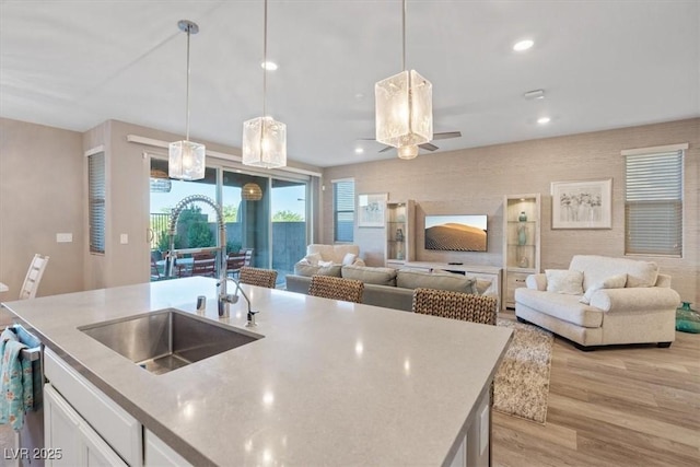 714 Rogue Wave St, Las Vegas, NV 89138 - kitchen with open floor plan, light wood-style floors, white cabinetry, decorative light fixtures, and recessed lighting