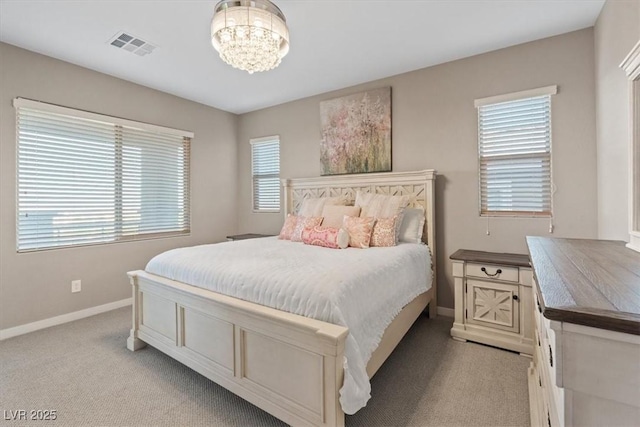 714 Rogue Wave St, Las Vegas, NV 89138 - bedroom with light colored carpet and a chandelier