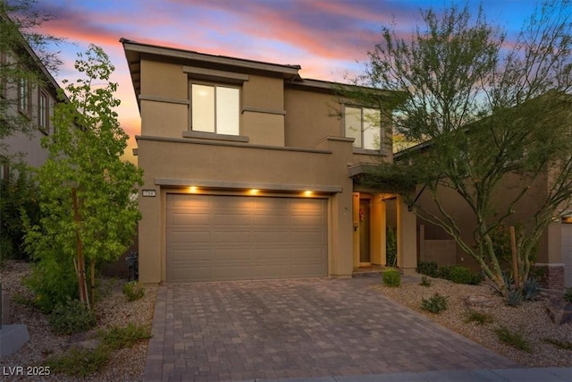 714 Rogue Wave St, Las Vegas, NV 89138 - view of front facade with stucco siding, an attached garage, and decorative driveway