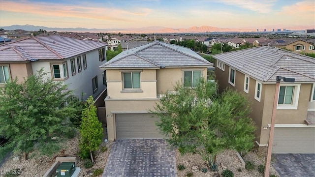 714 Rogue Wave St, Las Vegas, NV 89138 - view of front of property featuring stucco siding, a garage, a residential view, decorative driveway, and a tiled roof