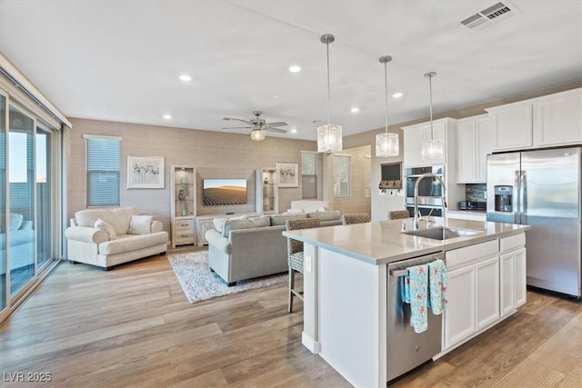 714 Rogue Wave St, Las Vegas, NV 89138 - kitchen with appliances with stainless steel finishes, open floor plan, recessed lighting, light countertops, and white cabinetry