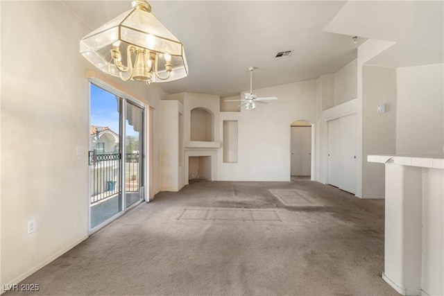6201 E Lake Mead Blvd Unit 210, Las Vegas, NV 89156 - unfurnished living room with carpet, a chandelier, ceiling fan, and arched walkways