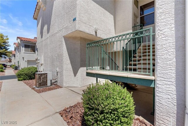 6201 E Lake Mead Blvd Unit 210, Las Vegas, NV 89156 - view of side of property with stucco siding and stairway