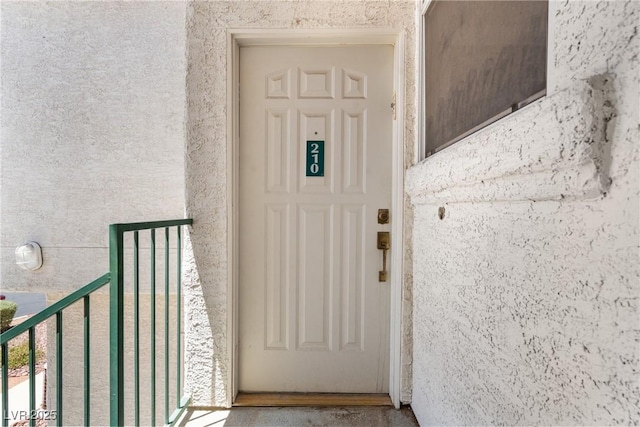 6201 E Lake Mead Blvd Unit 210, Las Vegas, NV 89156 - doorway to property featuring stucco siding and a balcony
