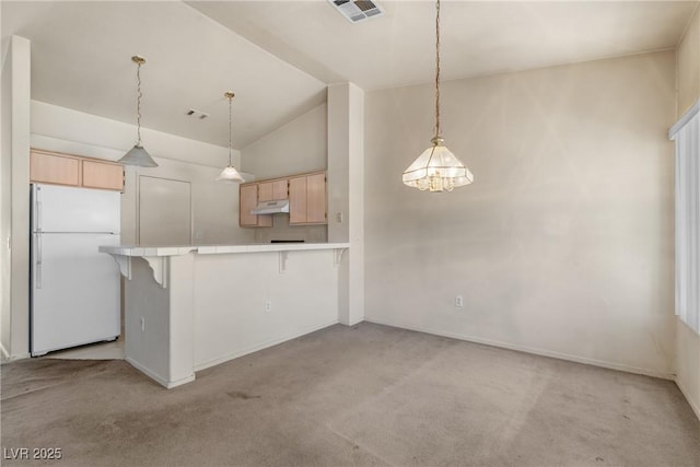 6201 E Lake Mead Blvd Unit 210, Las Vegas, NV 89156 - kitchen with freestanding refrigerator, light brown cabinets, under cabinet range hood, light carpet, and high vaulted ceiling