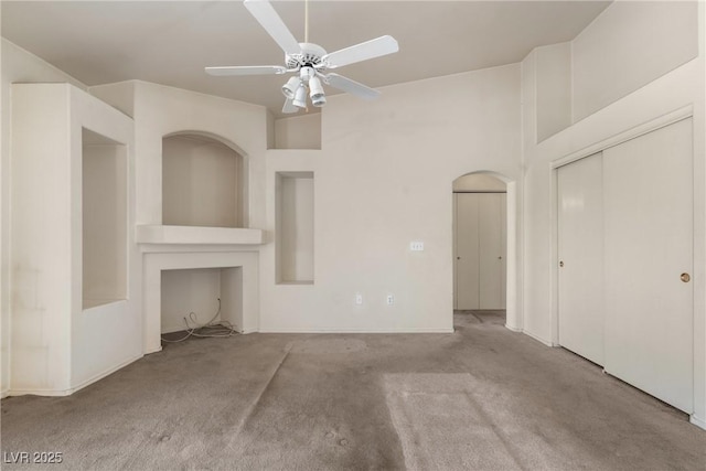 6201 E Lake Mead Blvd Unit 210, Las Vegas, NV 89156 - unfurnished living room featuring carpet, a ceiling fan, and arched walkways
