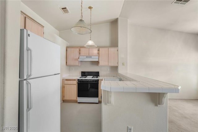 6201 E Lake Mead Blvd Unit 210, Las Vegas, NV 89156 - kitchen featuring white appliances, light brown cabinetry, under cabinet range hood, a peninsula, and tile counters