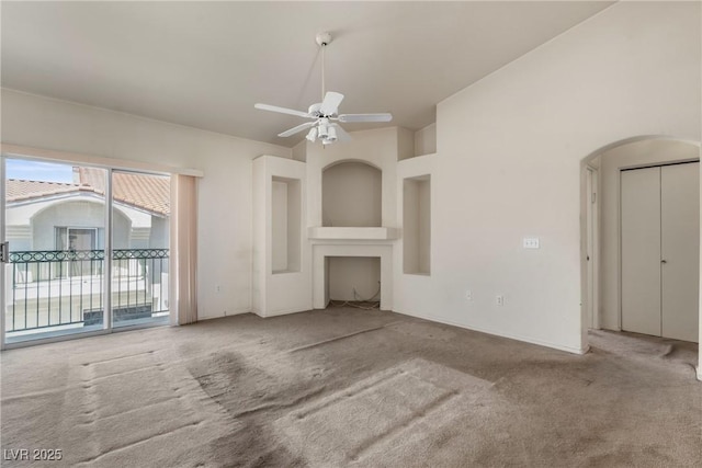 6201 E Lake Mead Blvd Unit 210, Las Vegas, NV 89156 - unfurnished living room with carpet flooring, arched walkways, and ceiling fan