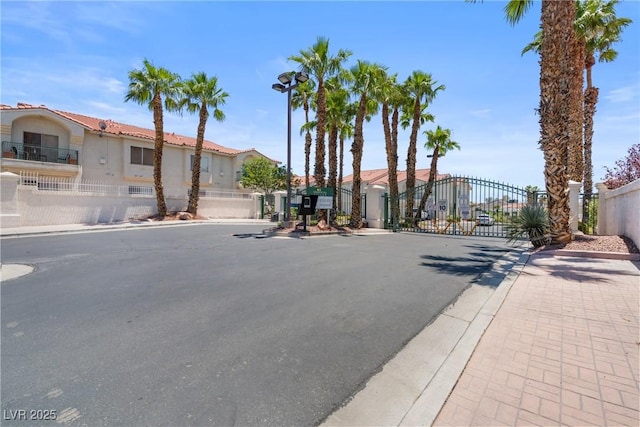 6201 E Lake Mead Blvd Unit 210, Las Vegas, NV 89156 - view of asphalt road featuring a gate, sidewalks, curbs, and a gated entry