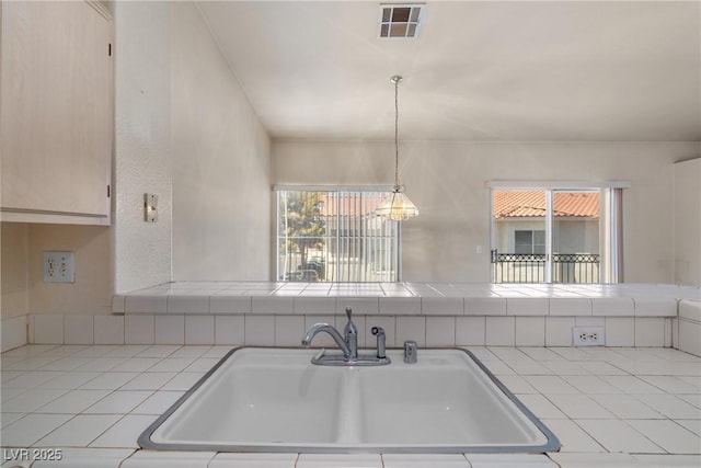 6201 E Lake Mead Blvd Unit 210, Las Vegas, NV 89156 - kitchen featuring tile counters, a chandelier, and decorative light fixtures