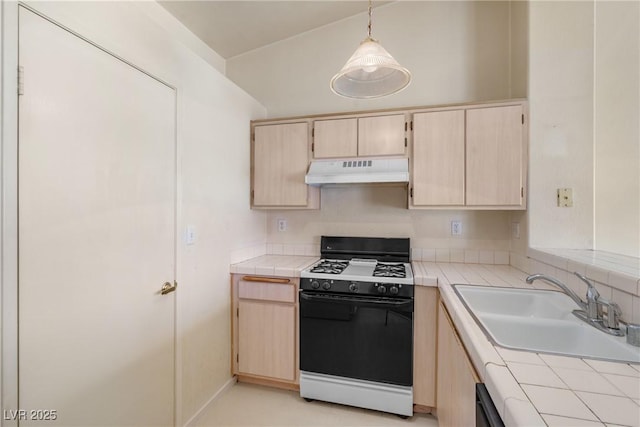 6201 E Lake Mead Blvd Unit 210, Las Vegas, NV 89156 - kitchen with black gas stove, under cabinet range hood, tile counters, and light brown cabinetry