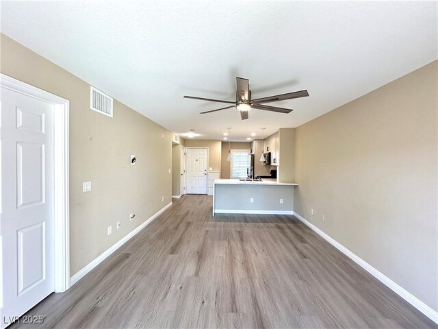 8070 W Russell Rd Unit 2070, Las Vegas, NV 89113 - unfurnished living room with light wood finished floors and ceiling fan