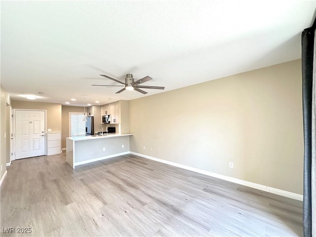 8070 W Russell Rd Unit 2070, Las Vegas, NV 89113 - unfurnished living room with ceiling fan, light wood-style floors, and recessed lighting