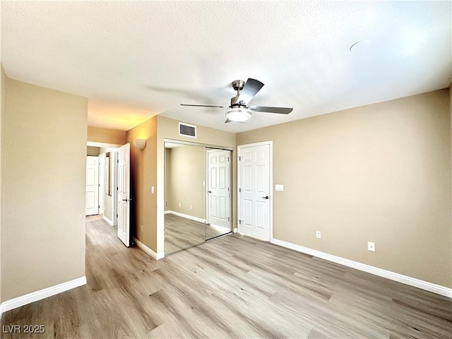 8070 W Russell Rd Unit 2070, Las Vegas, NV 89113 - unfurnished bedroom featuring light wood-type flooring, a closet, and a ceiling fan