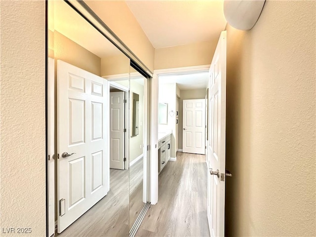 8070 W Russell Rd Unit 2070, Las Vegas, NV 89113 - hall with light wood-type flooring and a textured wall