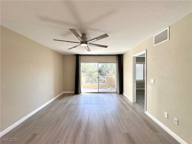 8070 W Russell Rd Unit 2070, Las Vegas, NV 89113 - unfurnished room with wood finished floors, a ceiling fan, and a textured ceiling